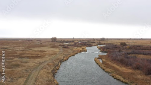 Beautiful drone view of Rio Grande River near Alamosa in Colorado, USA, with cold water flowing in a cloudy winter day. photo