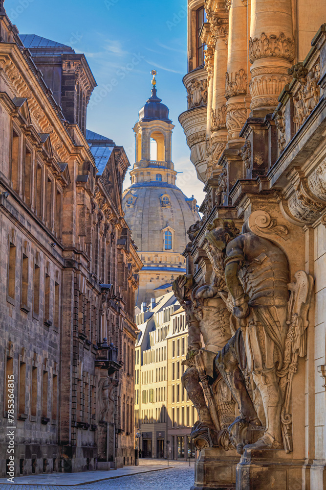 Cityscape - street view with sculptures of gatekeepers on the George Gate of Dresden Castle against the backdrop of the Dresden Frauenkirche, Dresden, Germany