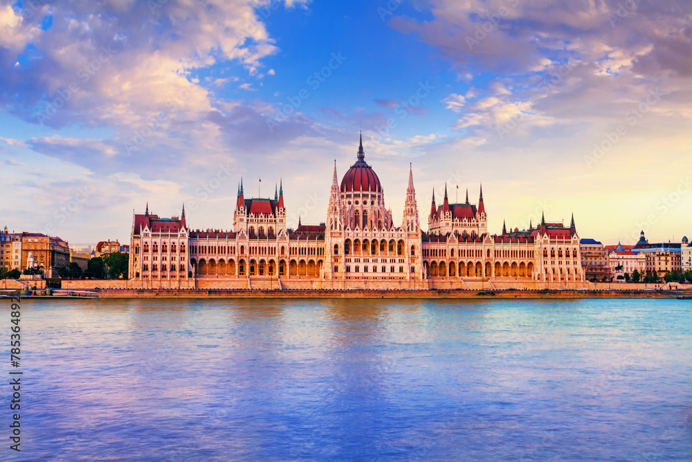 City landscape at sunset - view of the Hungarian Parliament Building in the historical center of Budapest on the bank of the Danube river, in Hungary