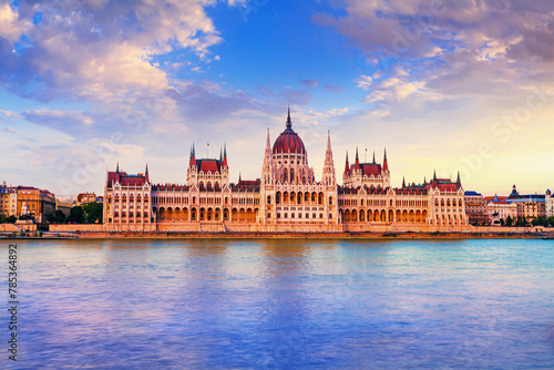City landscape at sunset - view of the Hungarian Parliament Building in the historical center of Budapest on the bank of the Danube river, in Hungary