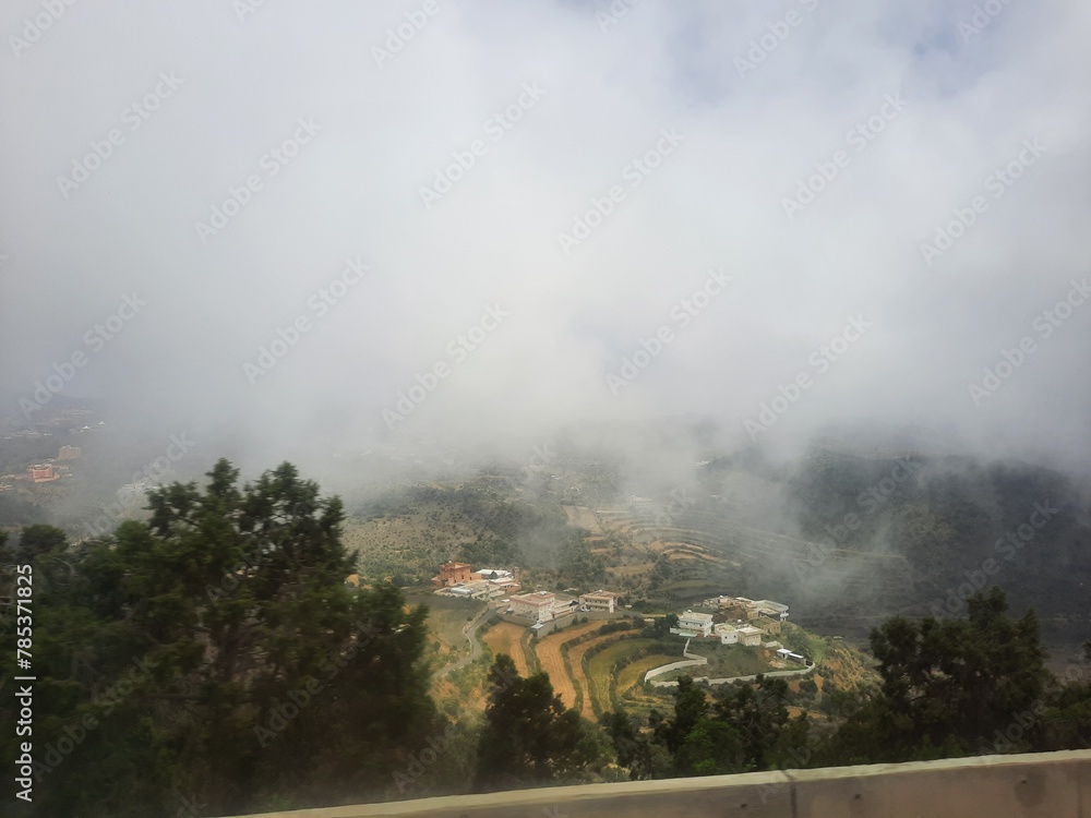 Fototapeta premium Mesmerizing natural beauty of Abha in Saudi Arabia in the summer season. High mountains, greenery, low clouds and fog are the beauty of Abha.