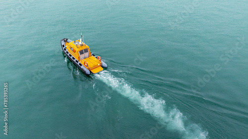 Orange rescue or coast guard patrol boat, patrolling. Police motor boat