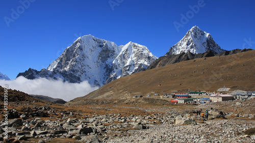 Lodges in Lobuche and snow covered mountains Tobuche, Taboche and Cholatse, Nepal.