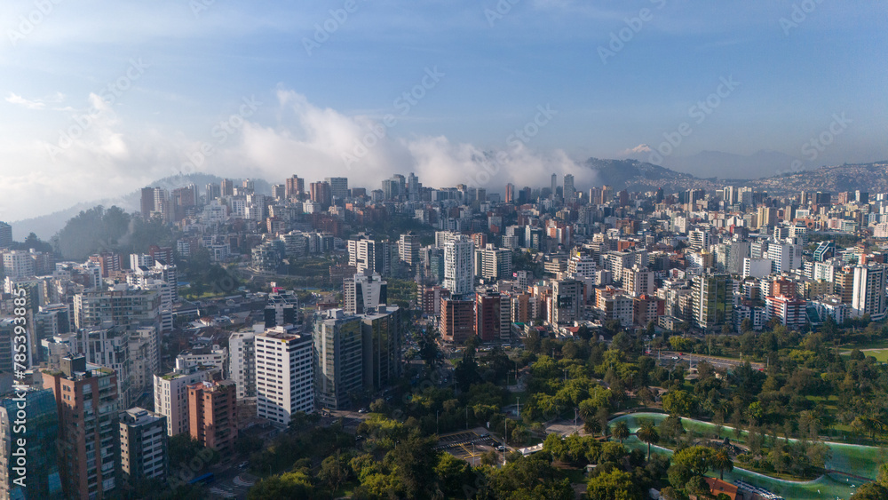 Aerial drone view of Quito capital city of Ecuador South America Parque La Carolina Sunrise early morning traffic