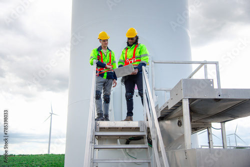 Wind turbine engineers plans to monitor wind turbine operation and maintenance in a wind farm, a sustainable energy industry concept