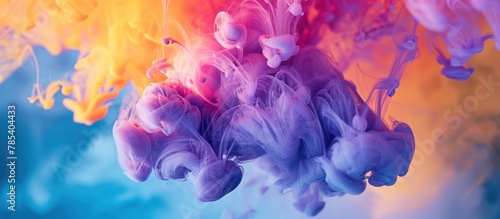 Detailed view of vibrant purple, yellow, and blue ink swirling and blending creating colorful abstract patterns.
