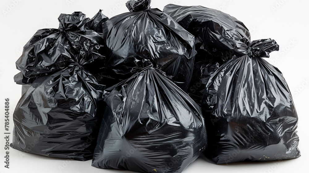 Several black garbage bags filled and tied, isolated on a white background.