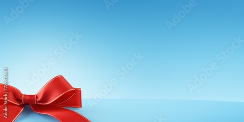 Red ribbon with bow on sky blue background  Christmas card concept. Space for text. Red and Sky Blue Background