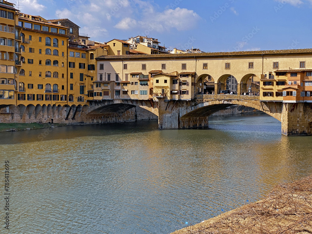 Obraz premium View from the Ponte Vecchio over the Arno river, in the ancient medieval city of Florence, Italy.
