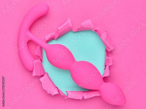 anal plug dildo sex toy over pink background