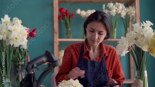 Florist woman counting cash dollars working in her flower shop
