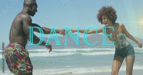 Image of dance text over smiling african american couple dancing at beach