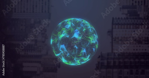 Image of globe made of shapes rotating over computer hardware