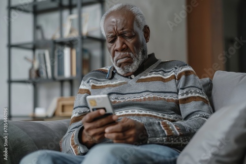Upset and sad man sitting at home on couch in living room, cheated senior mature african american man displeased holding phone and bank credit card, rejected fund transfer error, Generative AI