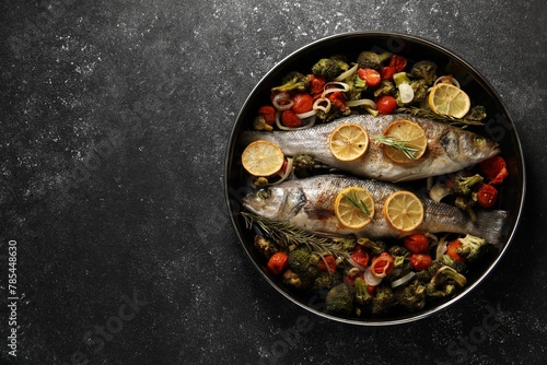 Baked fish with vegetables, rosemary and lemon on black textured table, top view. Space for text