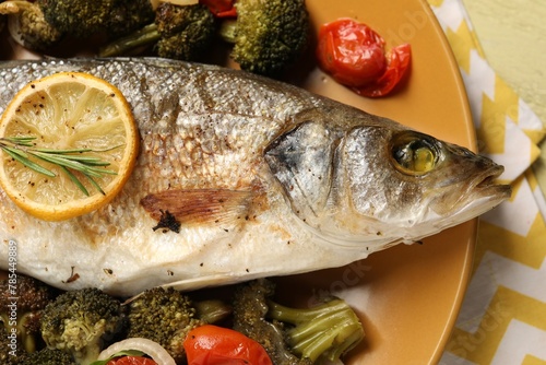 Delicious baked fish and vegetables on table, top view