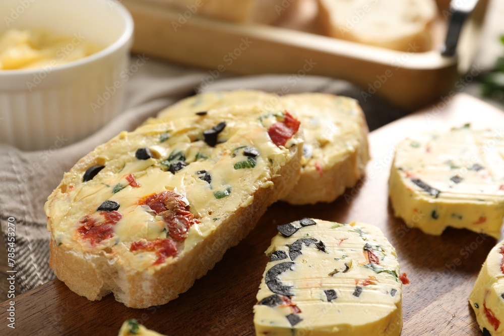 Tasty butter with olives, chili pepper, parsley and bread on table, closeup Tasty butter with olives, chili pepper, parsley and bread on table, closeup