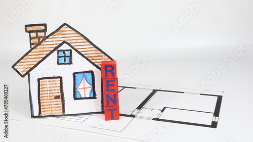 Sign with rent writing, model house on the table, finance or insurance house concept.