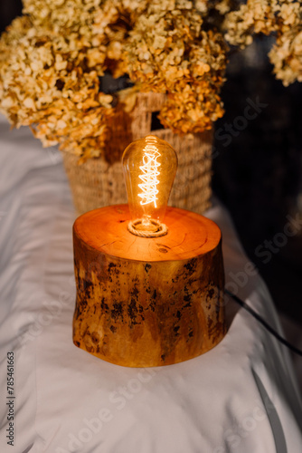 Table lamp made of wood. Edison electric lamp. Incandescent lamp.
