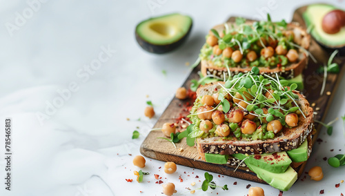 Vegan sandwich with avocado, chickpeas and microgreen sprouts