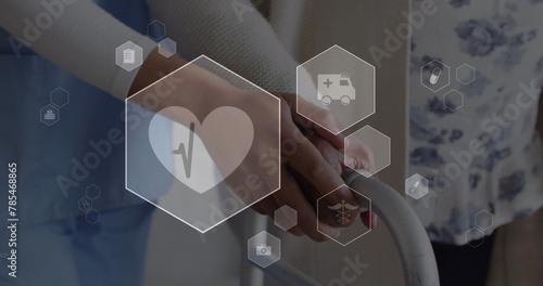 Image of icons in hexagons over hands of caucasian nurse assisting senior patient in walking