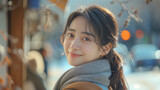 A portrait showcasing the warmth of a young Korean woman's smile amidst the colorful bokeh lights of a winter evening.