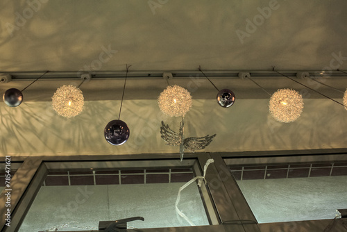 Decorative lamps hanging on the ceiling with the shadow on the wall. Interiors decoration.