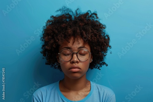 Portrait of Young Curly Haired Woman Covering Half of Face, Sighing from Tiredness and Sleep Deprivation in Studio, Standing in Horizontal Position After Nap photo