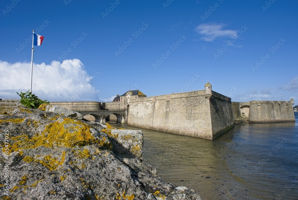 Port-Louis, France - Apr 1, 2024: Port-Louis Citadel and memorial to the Patriots shot in June 1944 during Second World War. Sunny spring day. Selective focus