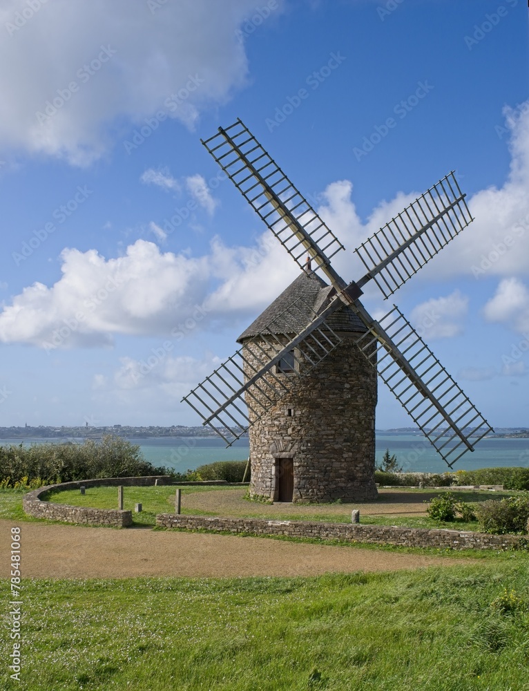 Plouezec, France - Apr 9, 2024: Wonderful landscapes in France, Brittany. De Craca windmill in Plouezec. Sunny spring day. Selective focus.