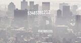 Image of numbers and data processing over cityscape