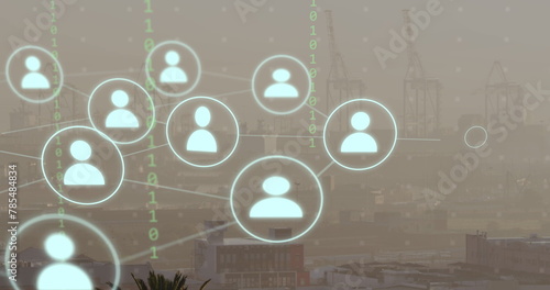 Image of network of connections with icons and binary coding over cityscape