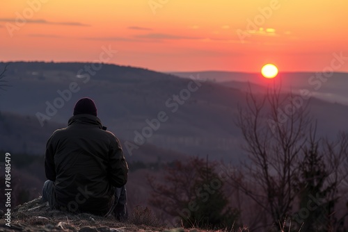 Relaxing Moment: Person Taking a Break at Mountain Top, Admiring the Sunset