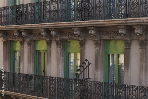 Exterior facade of historical house with apartments in Barcelona, Spain. Urban vintage background. The building with carved balconies.