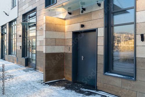 A building with a black door and a window on the side