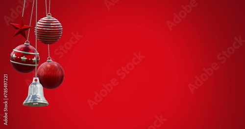 Image of swinging baubles and bell against red background