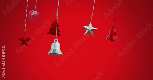 Image of bells, star, gift box swinging against red background