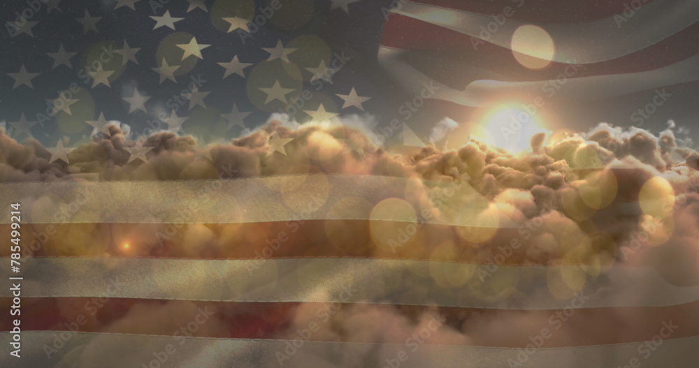 Fototapeta premium Image of glowing spots and sun shining on sky with clouds over american flag