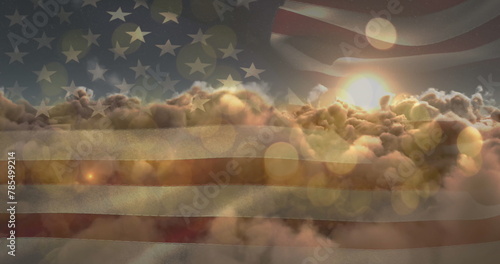 Image of glowing spots and sun shining on sky with clouds over american flag