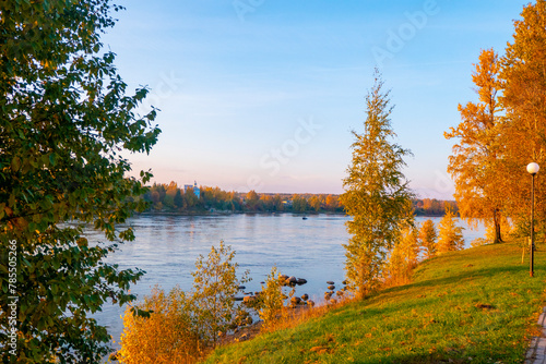 Obraz na płótnie Colorful autumn landscape with birch grove with golden foliage on the shore of the lake and beautiful reflections at sunset. High quality photo w salonie