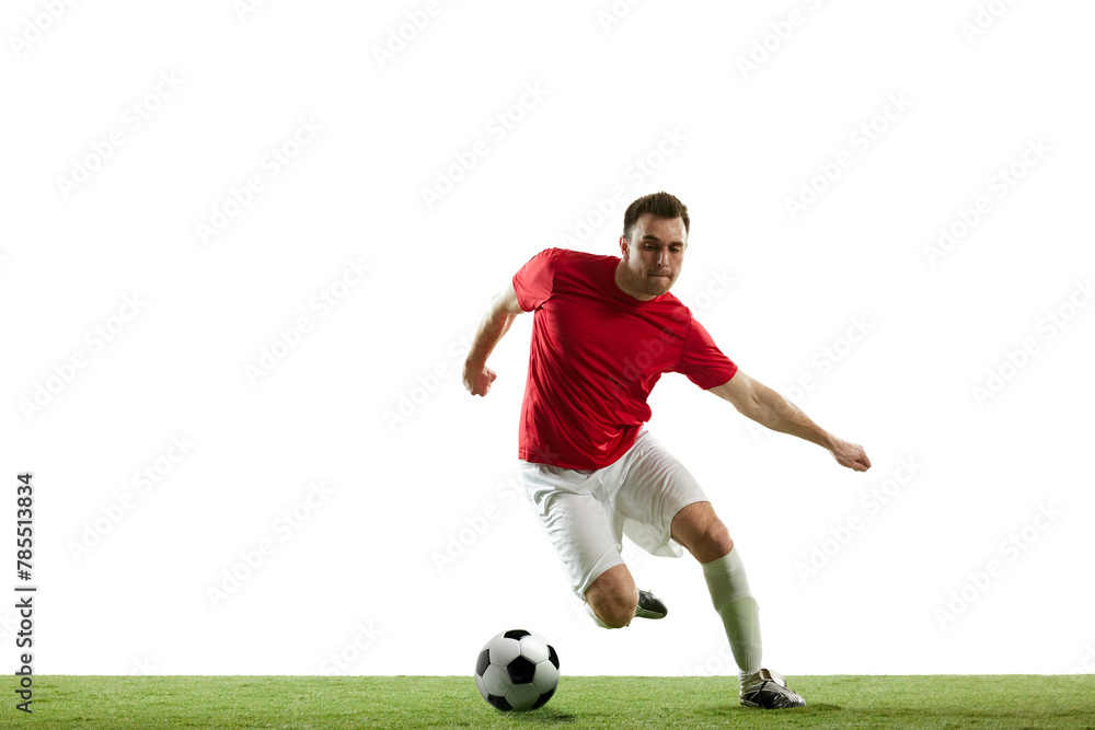 Dynamic image of young man, soccer player in motion with ball, running, training isolated on white background. Concept of professional sport, game, competition, tournament, action, active lifestyle