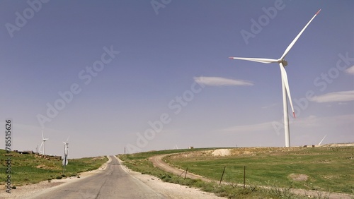 Photos walk through field of windmills against clear sky
