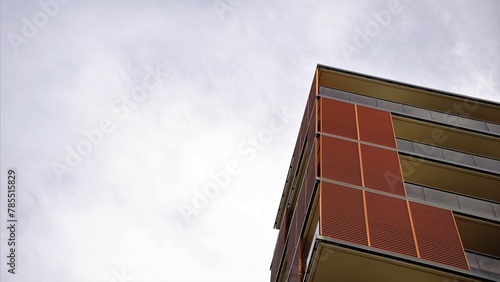 corner of facade of modern residential building against the sky