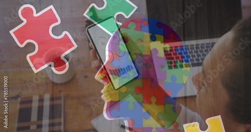 Image of colourful puzzle over caucasian woman with smartphone