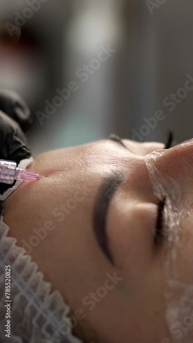 Mesotherapy, biorevitalization and Cosmetology concept. Face mesotherapy procedure in a beauty salon. Beautician doctor makes injections into face skin of woman.