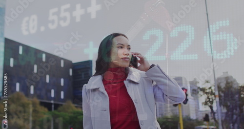 Image of stock market data processing over asian woman talking on smartphone on the street