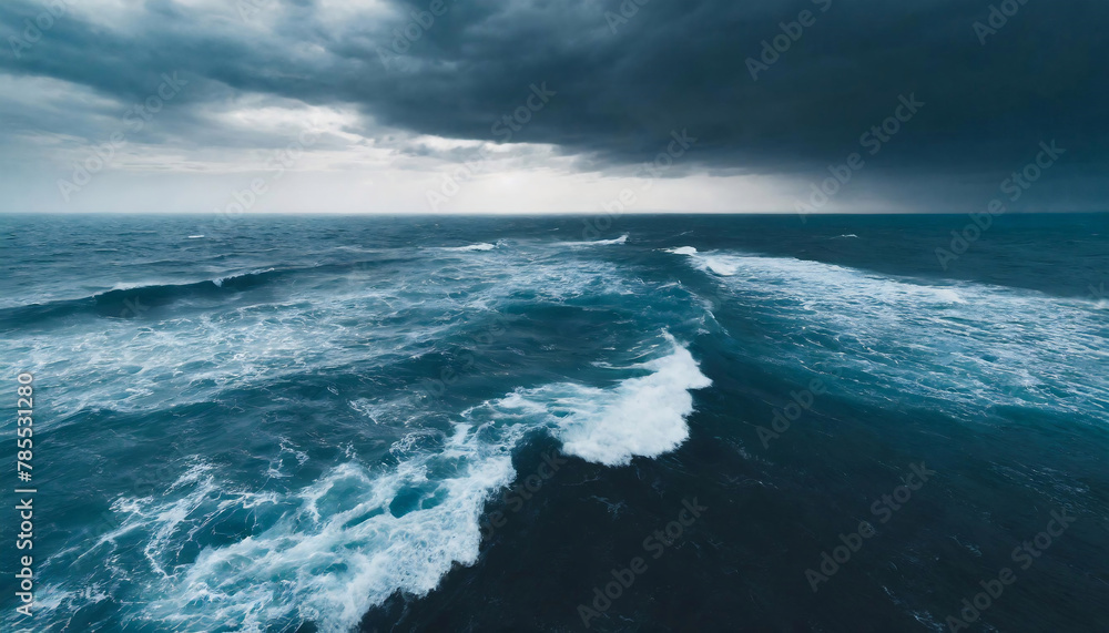 Close-up view of turbulent big wave in a stormy sea under a cloudy sky.