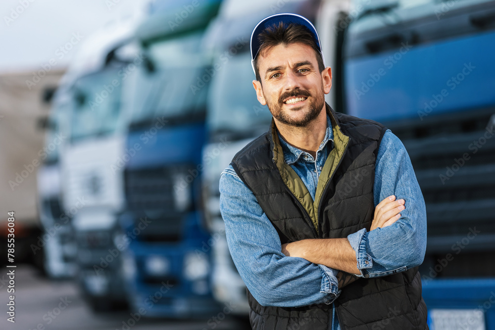 Happy confident male driver standing in front of his truck. Happy confident male driver standing in front of his truck.
