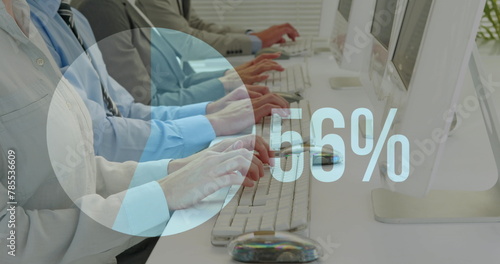 Image of increasing percentage over mid section of businesspeople typing on keyboards at office