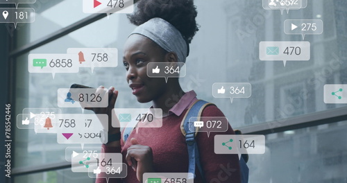Image of notification bars over african american woman talking on speaker of cellphone